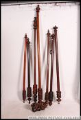 A collection of Victorian mahogany large curtain rails of think form being well carved with finial