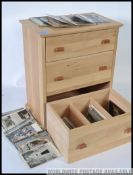 A large collection of 20th century topographical postcards set within a chest of drawers