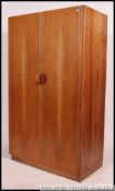 An original Gordon Russell walnut single wardrobe.