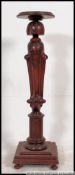 A stunning Regency mahogany carved torchere / plant stand.