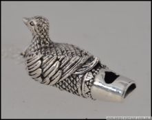 A silver white metal duck whistle on a silver chain . Whistle 4cm 16.