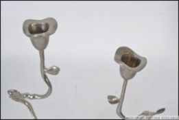 A pair of white metal danish candlesticks in the form of flowers / twigs.