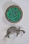 An unusual silver and green stone brooch with fret worked surround and wire worked centre together