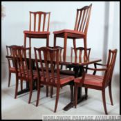 A good quality large retro G-Plan extending dining table raised on shaped base with stretcher.