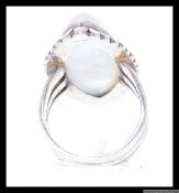 A silver dress ring with large oval gem set stone stamped 925. Size P.