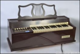A vintage / retro 1970's Rosedale Electric Chord Organ musical instrument in brown plastic body