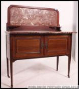 An Edwardian mahogany inlaid marble top washstand.