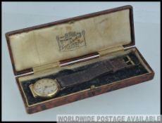 A 9ct gold Edwardian gentlemans wristwatch leather half leather original strap,