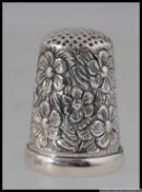 A silver white metal thimble with a enamel plaque depicting a cat marked 925 12g