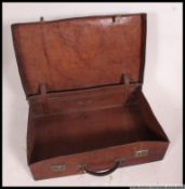 An early 20th century large high quality solid leather suitcase complete with the leather handle