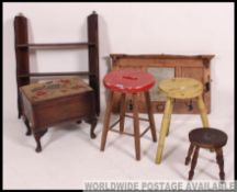 A collection of vintage milking parlour stools together with a wall mounted coat rack,