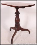 A 19th century Georgian mahogany tilt top tripod wine table.