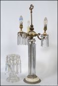 A stunning early 20th century table lamp lustre having long glass droplets under 3 branch lamp