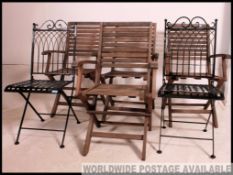 A set of 4 folding wooden garding chairs in teak together with a pair of folding metal garden cafe