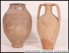 A large 20th century garden amphora pot of terracotta form together with another large garden pot