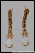 A pair of vintage 10k gold opal drop earings. Marked 10k Mexico. Measures 3cms. Weight 1.9g.
