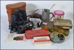 A dealers lot to include vintage tins, cased binoculars,