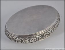 An eastern silver snuff box having squeeze side opening. Chased with flowers etc of lozenge form.
