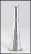 A silver pepper pot in the form of a hunting horn bearing marks to base Sterling silver.
