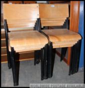 A set of 10 vintage mid century stacking chairs having panel wood seat and back rests being raised