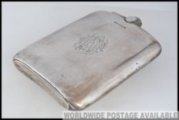 A large silver hallmarked hip flask ( a/f missing top ) having an engraved cartouche to centre,
