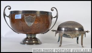 An oval form silver plate / EPNS revolving bacon warmer stamped to base along with an Oak and