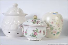 A large Poole Pottery ginger jar together with a vintage tureen with cover having apple finial.