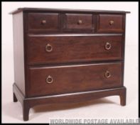 A Stag mahogany minstrel chest of drawer raised on shaped legs with a flared top above Measures: 72