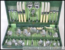 A vintage faux leather cased canteen of cutlery in excellent condition being stamped Warranted