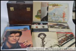 A collection of vintage LP vinyl records and singles to include pop, rock and various genres.