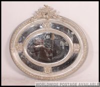 A stunning large silvered Venetian oval mirror.