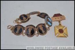 A vintage National Teachers of Dance enamel badge bracelet being re-fashioned together with a bar