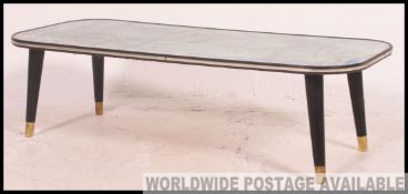 A 1950's retro pictorial coffee table with continental riviera scene signed G Casulotti.