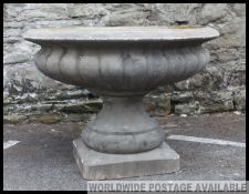 A fabulous large Campana urn - garden planter constructed of reconstituted stone having plinth base