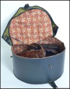 A vintage hat box with 3 vintage hats to
