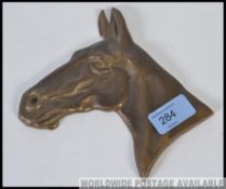 A 20th cast bronze plaque sculpture stud