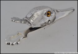 A silver plated clip in the form of a du