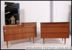 A retro 1950's Beehive teak wood chest of drawers raised on tapered legs together with a matching
