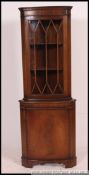A 20th century mahogany corner display u