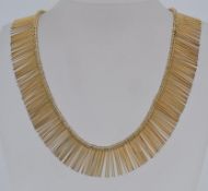 A vintage gold tone metal fringe necklac