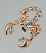 A yellow metal brooch in the form of a s