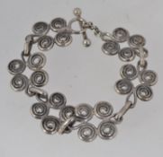 A vintage white metal swirl link bracele
