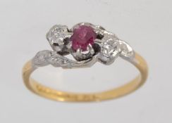 A hallmarked Birmingham 18ct and platinum ring with central red stone possibley a red emerald