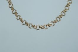 A vintage yellow metal choker necklace with round and geometric links lobster claw clasp.