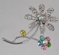 A vintage white metal flower brooch with