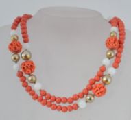 A vintage coral, opaque and gold tone gl