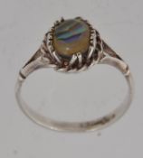 A silver dress ring with central oval ab