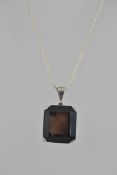 A large silver and smokey quartz pendant