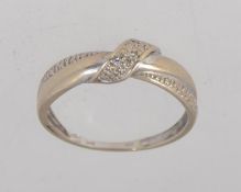 A tested 9ct gold cross over ring set wi