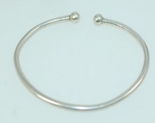 A vintage white metal silver bangle brac